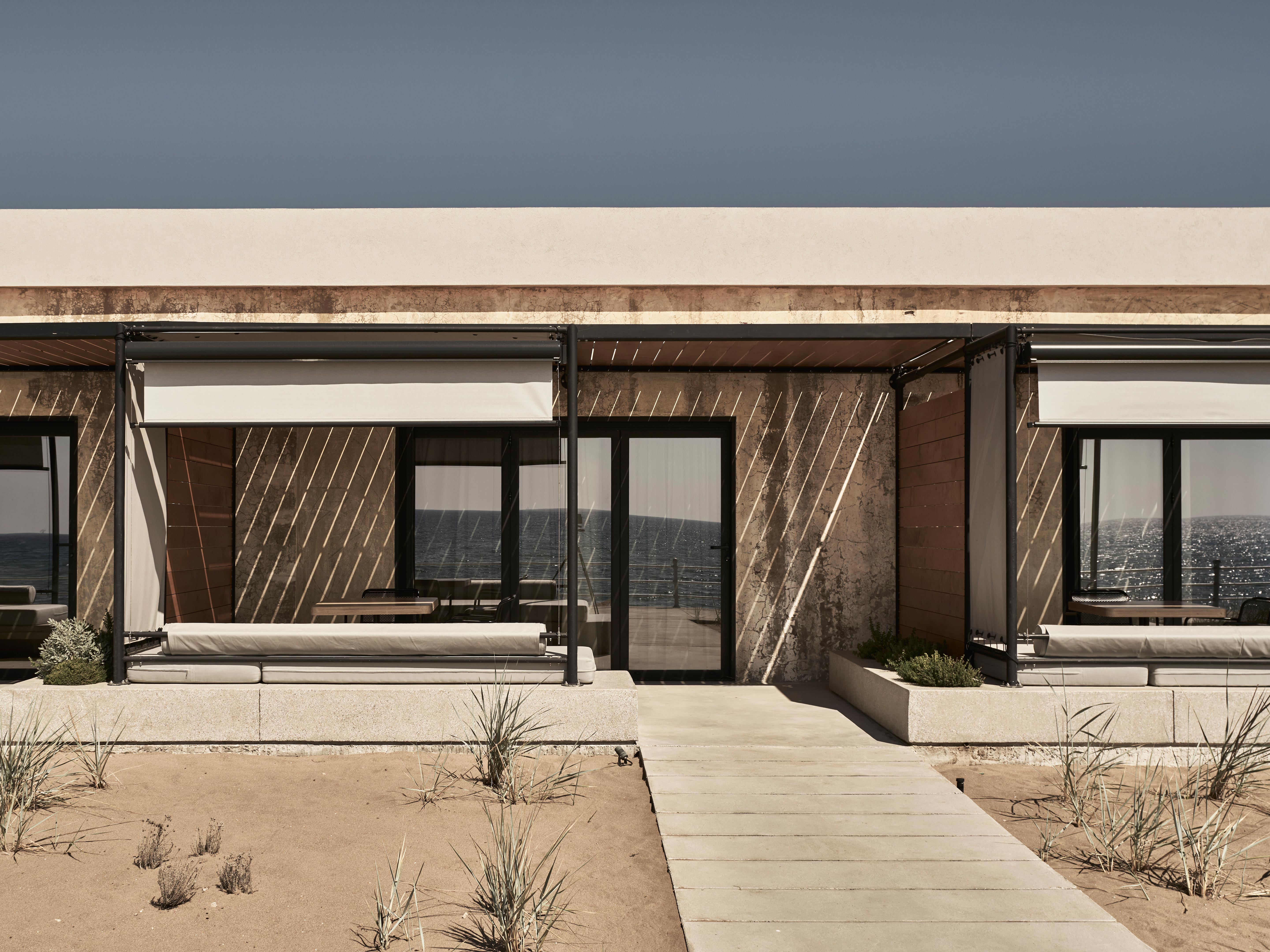 Dexamenes seaside hotel beachfront wine tank suite exterior design in Kourouta